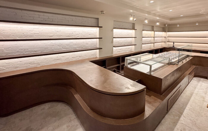 Finished deep coffee colored microcement commercial furniture counter in a Toronto gelateria after two coats.