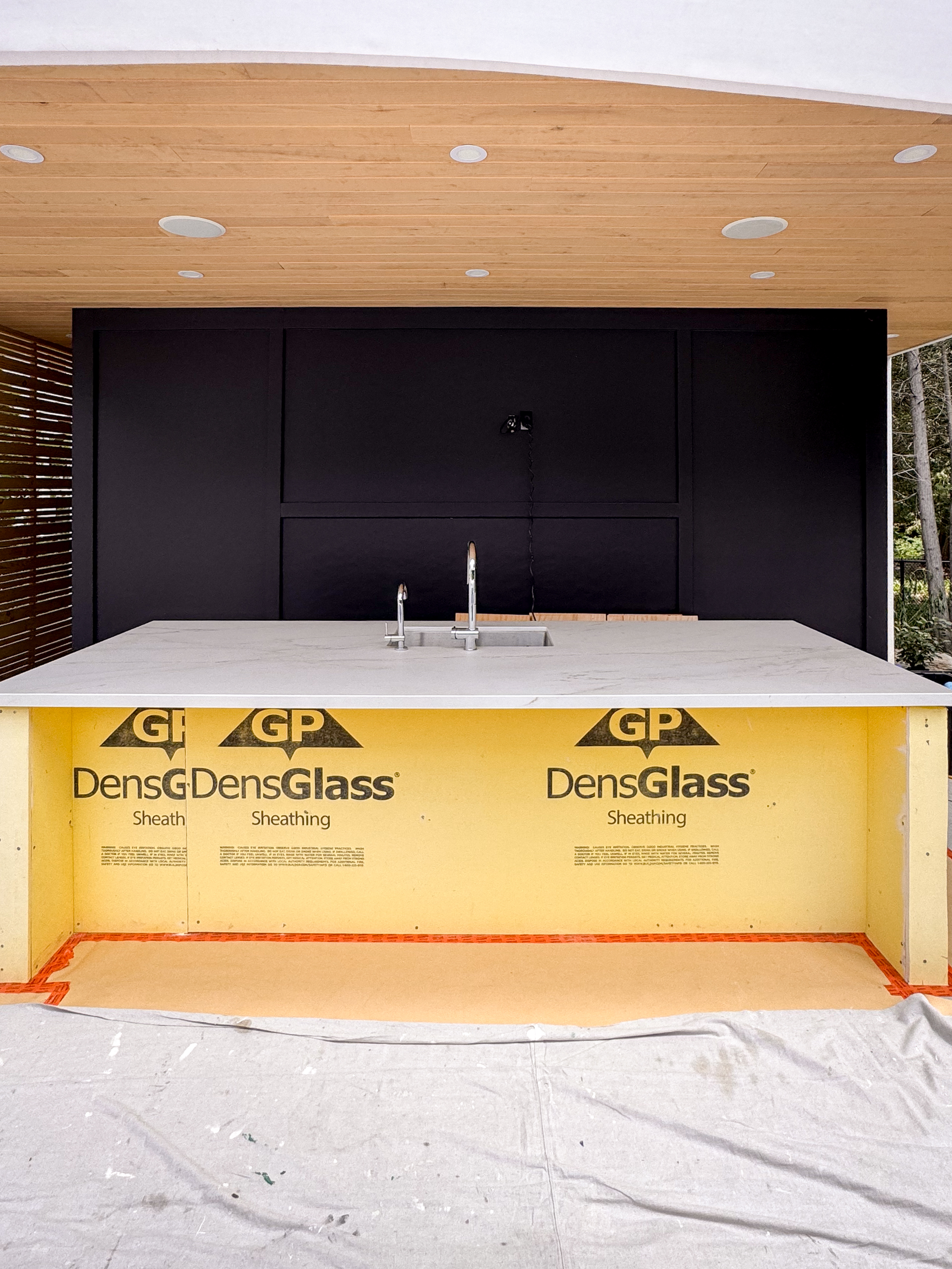 outdoor-microcement-kitchen-cabinet-erin-toronto-9 The unfinished framing of an outdoor kitchen island constructed with a raw Deco Shield substrate before the application of a microcement overlay.