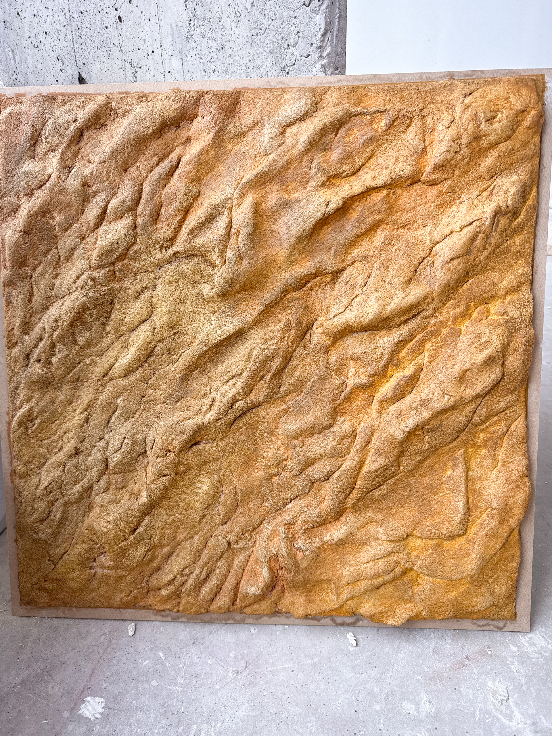 Custom warm orangey-brown rock effect wall toronto feature installation crafted for a residential client space.