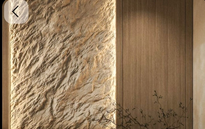 Custom rock effect wall toronto feature installation adjacent to custom millwork illuminated by soft white LED strip lighting.