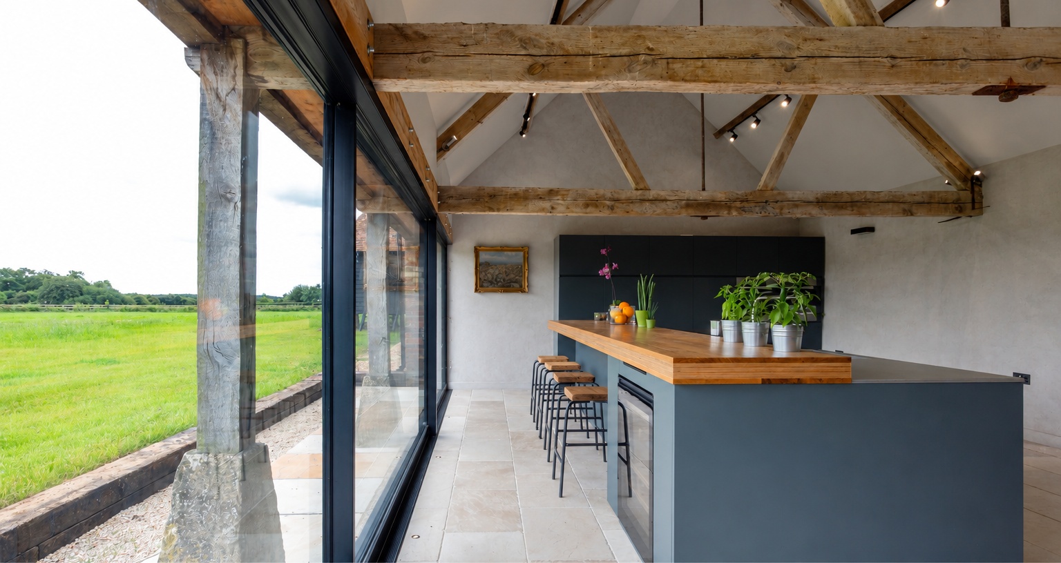 soft-grey-limewash-farmhouse-kitchen-breakfast-bar-prince-edward-county Soft grey limewash walls in modern farmhouse kitchen with exposed wood beams and dark cabinetry