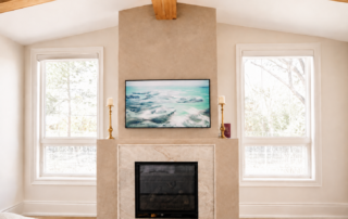 Taupe Venetian plaster on fireplace with creamy stone surround and exposed wood beams in a luxury Kleinburg ensuite
