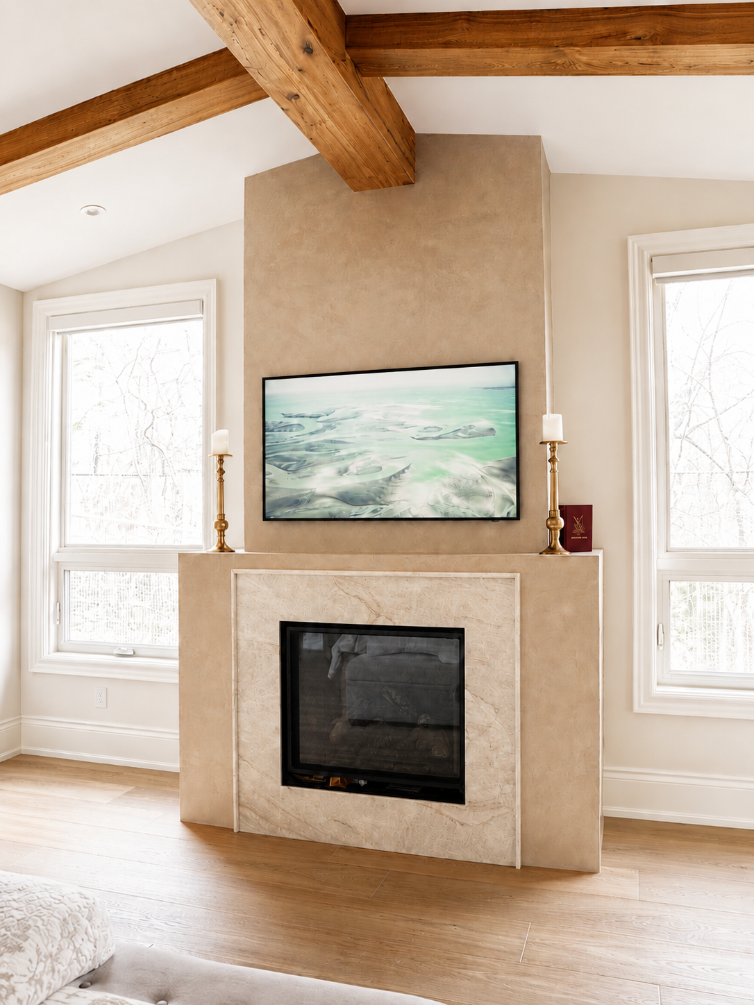 venetian-plaster-fireplace-world-map-design-master-bedroom9 Taupe Venetian plaster on fireplace with creamy stone surround and exposed wood beams in a luxury Kleinburg ensuite