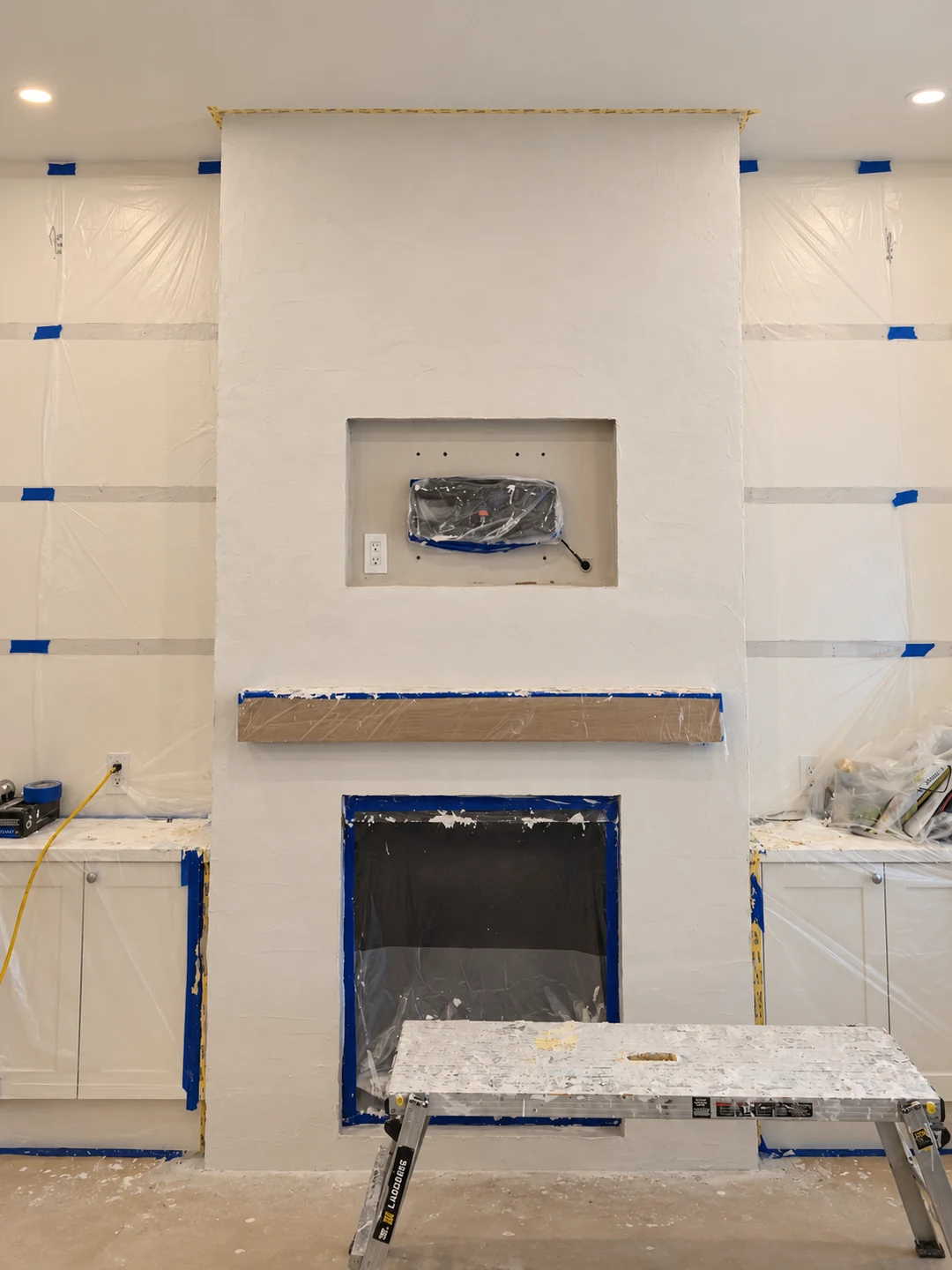 Reinforcing mesh and preparation coat used to level a stone fireplace before microcement application in Toronto.