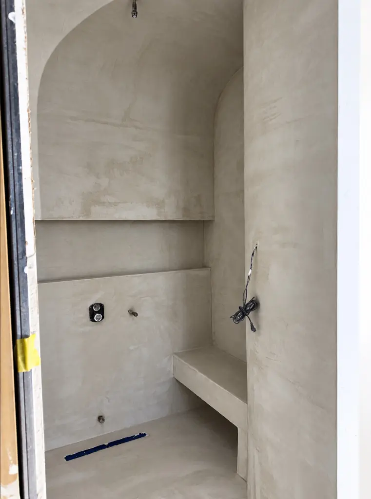 Prepared shower niche, bench and sloped floor in a Toronto bathroom before microcement application.